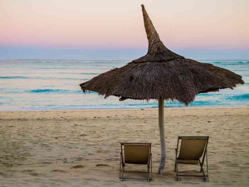 Traditional straw beach umbrella on beach Anakao, madagascar