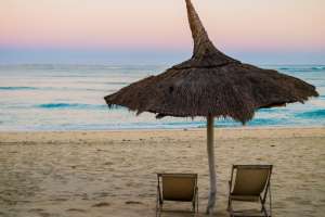 Traditional straw beach umbrella on beach Anakao, madagascar